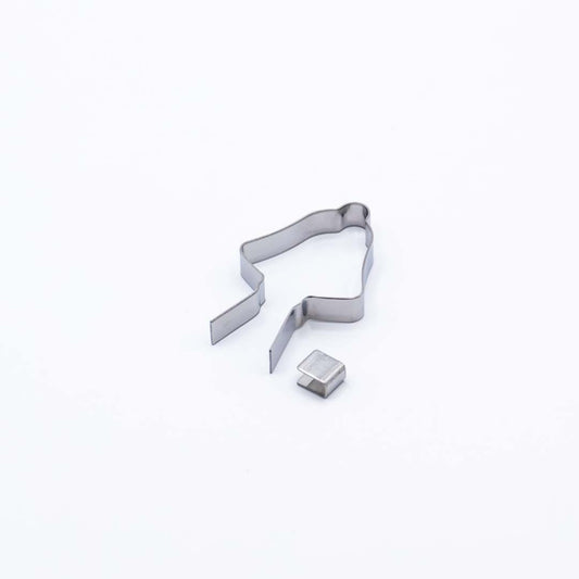 Metallic lollipop mold shaped like a Christmas bell on a white background