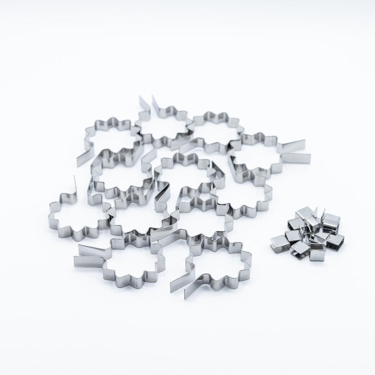 A set of stainless steel sunshine shaped lollipop molds on a clean white background.