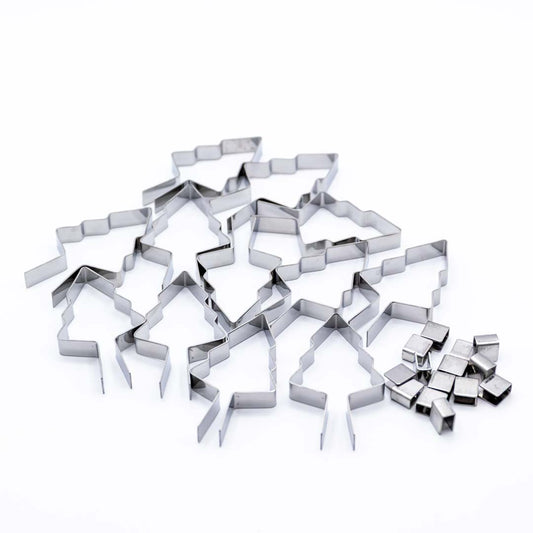 Set of metal lollipop molds in a christmas tree shape on a white background