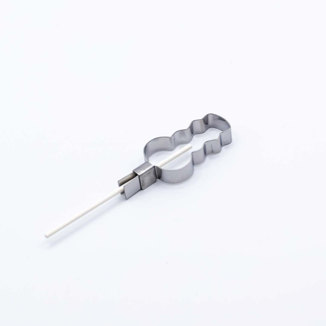 Metallic snowman shaped lollipop mold with stick on a white background