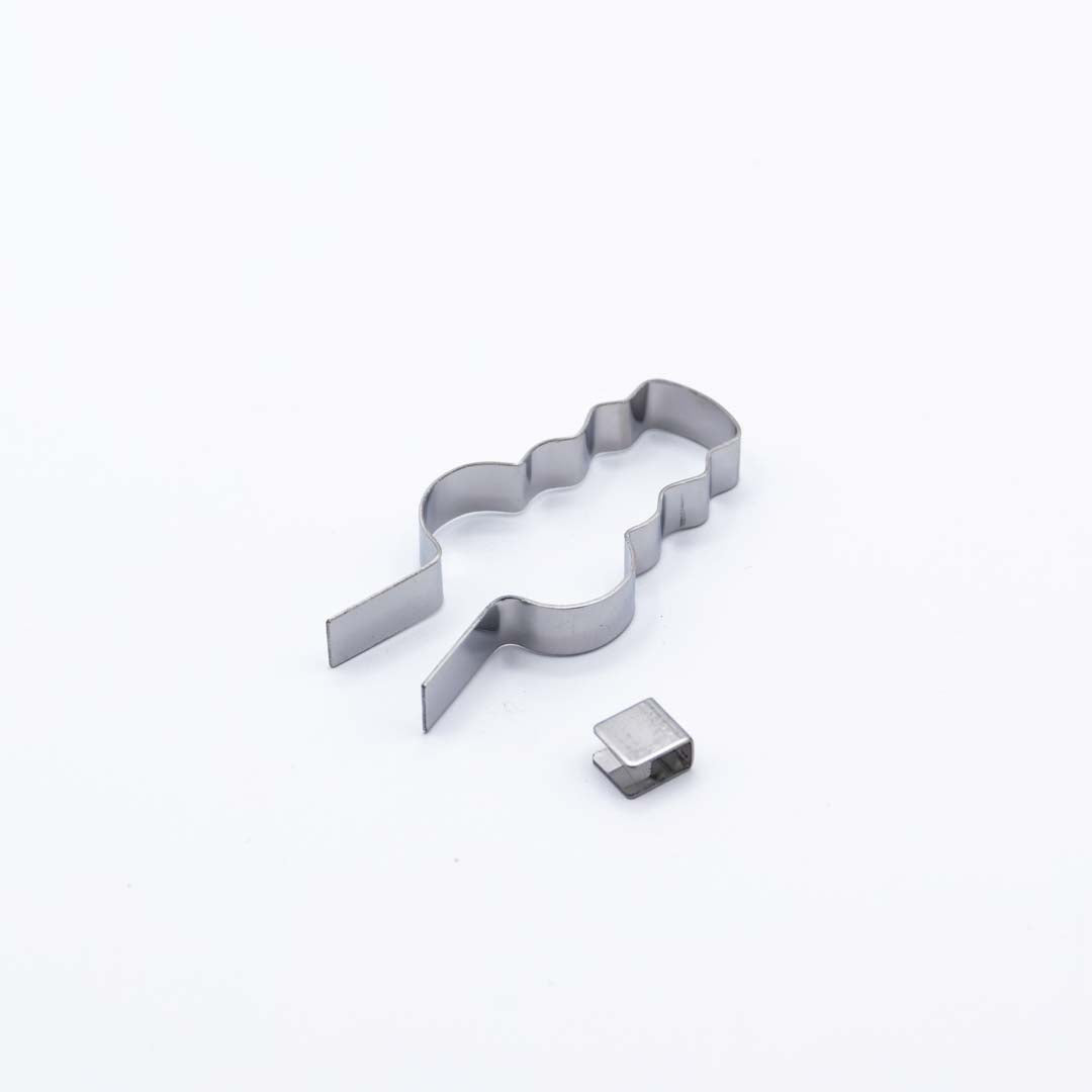 Metallic lollipop mold shaped like a snowman on a white background