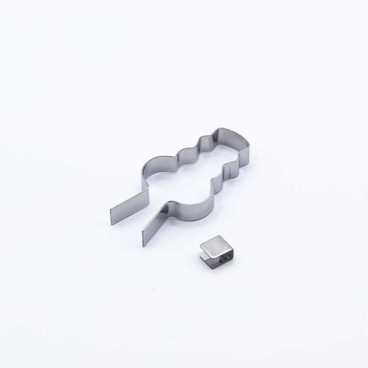 Metallic lollipop mold shaped like a snowman on a white background